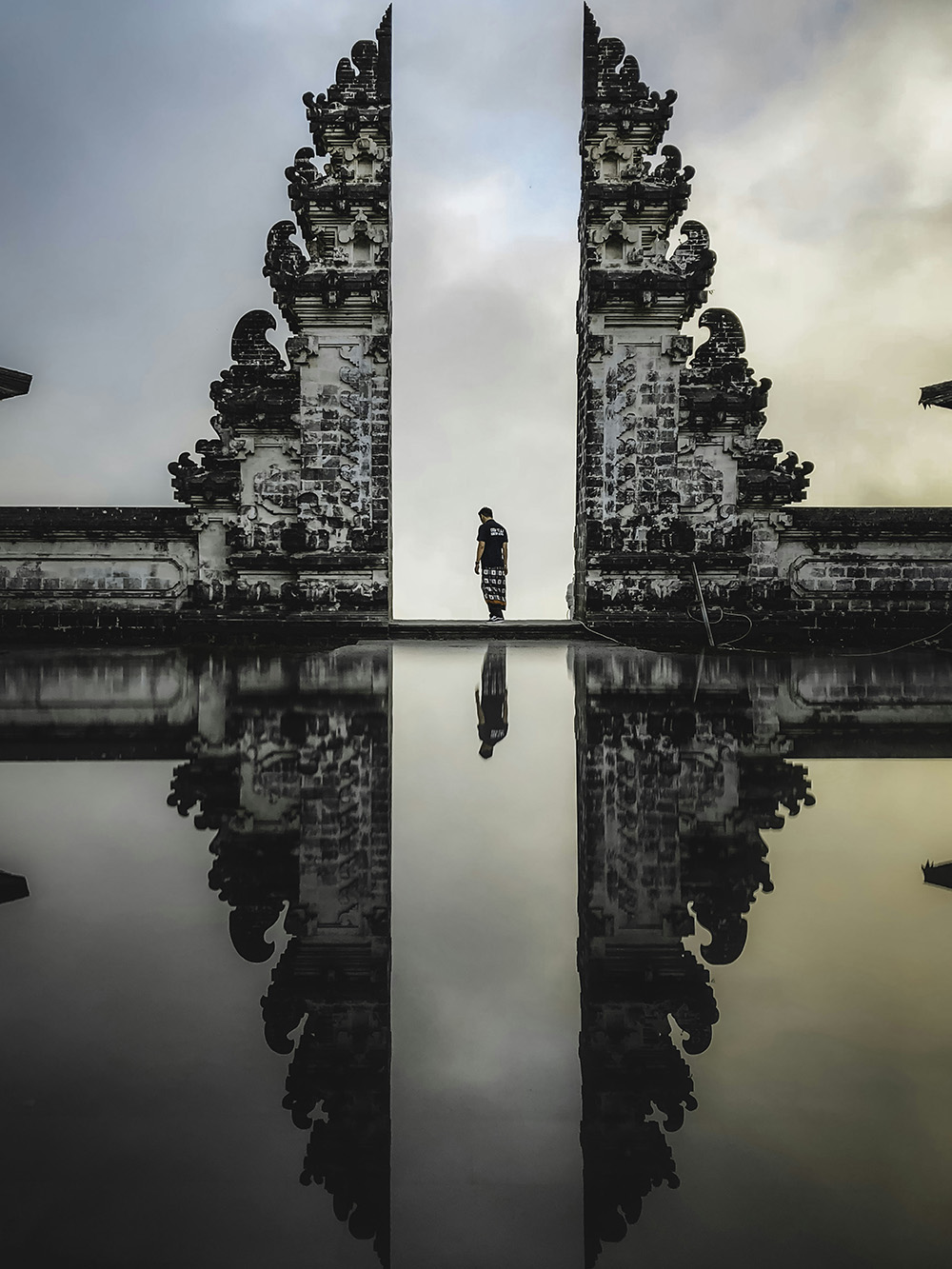Photo of man standing in ancient ruin in Bali